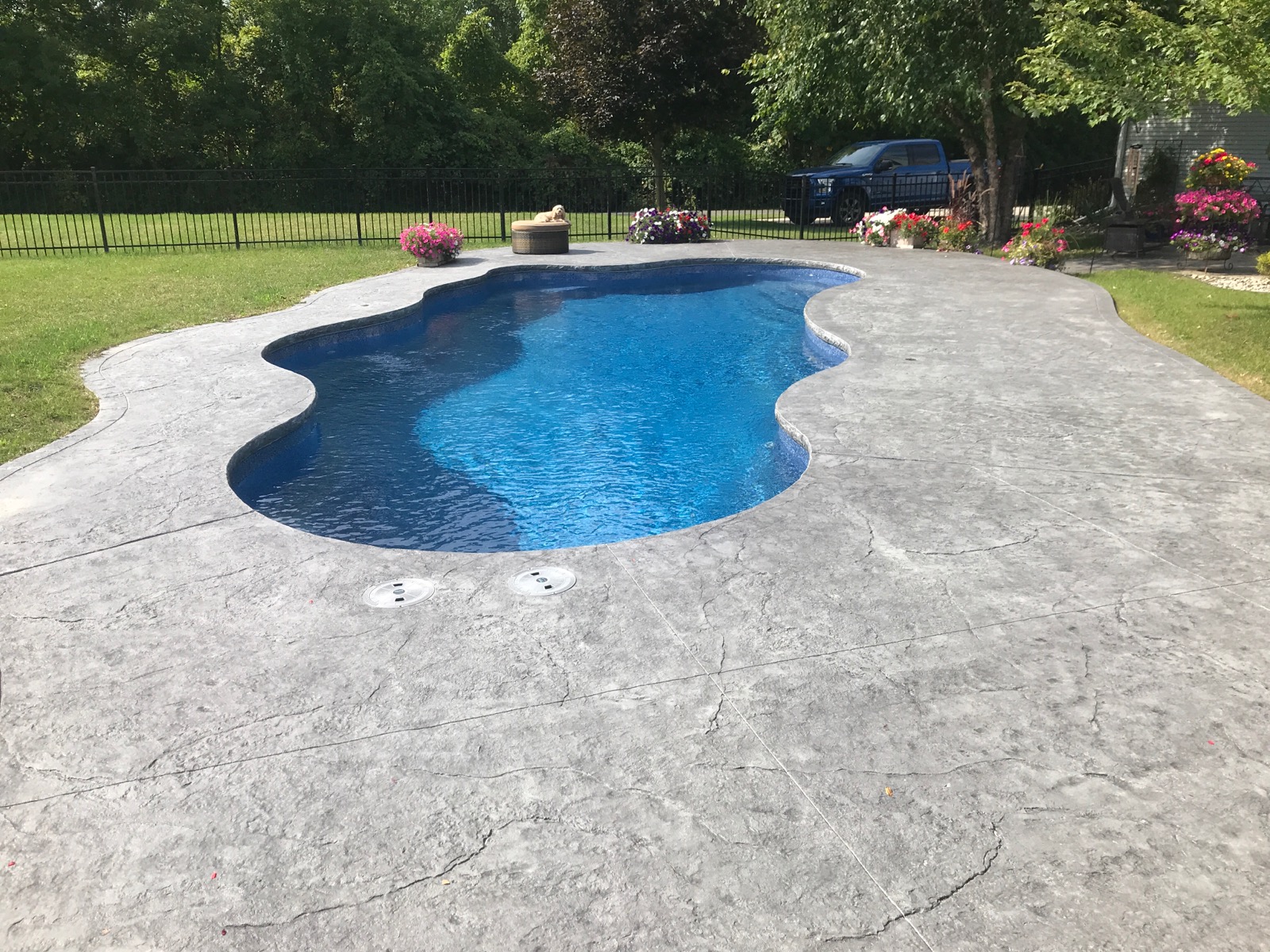 Cancun fiberglass swimming pool with stamped and dyed concrete patio