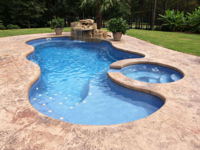 cancun deluxe with stamped and dyed concrete and custom waterfall