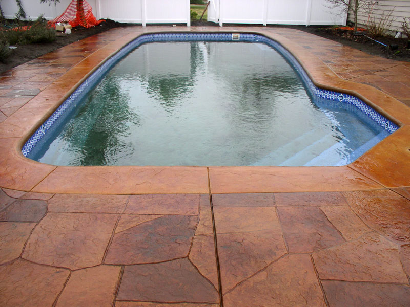 Carmel stamped and dyed concrete fiberglass pool